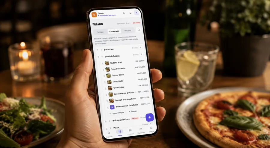TapTapMenu admin panel in hand at a restaurant table